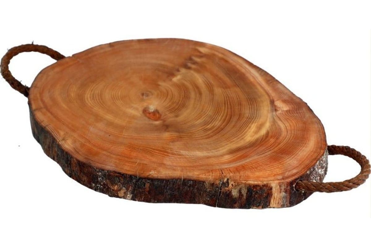 Shaped wood — Natural growth rings and a bark edge on a round cedar tray.
