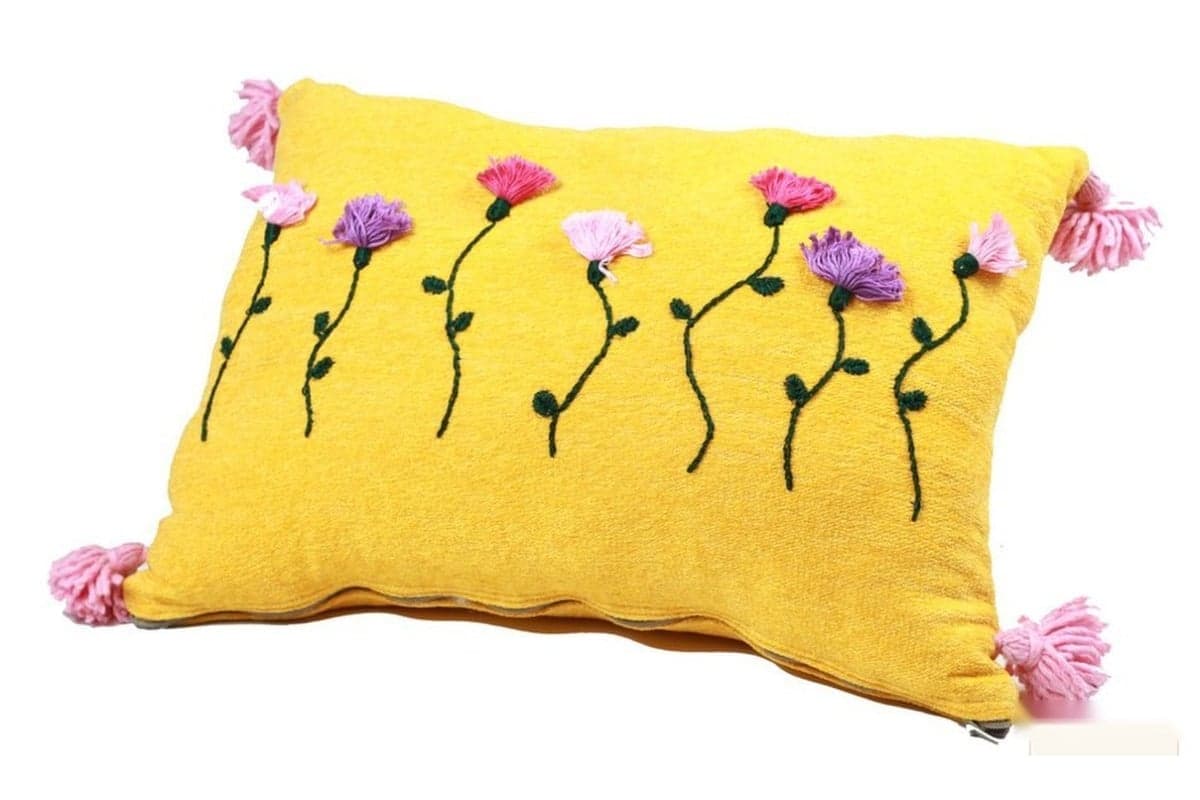 Embroidered textiles — Raised flowers, coloured threads and tassels on a cushion from the selection.